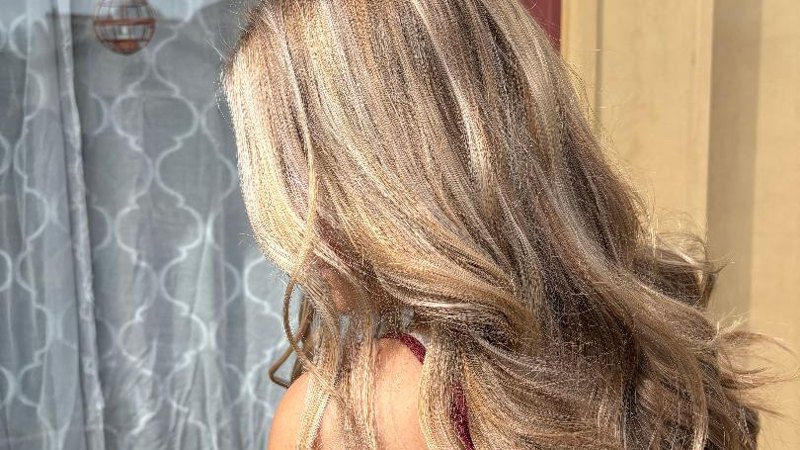 Long blonde dimensional highlights styled at Entourage Salon